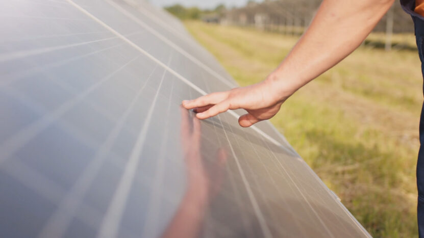 A man checking the quality of the panel with his hand